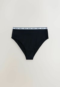 Black cotton brief with a white elastic waistband featuring "NEXT" printed in black. Simple design, smooth texture, and full coverage cut.