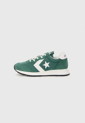 Green suede sneaker with white star and chevron design, white laces, and a black rubber sole. Classic athletic style, low-top silhouette.