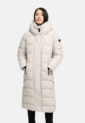 Long, light beige padded coat with a high collar, vertical quilting, side pockets, and black accents on sleeves.