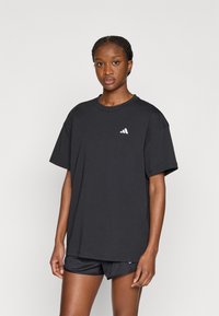 Μαύρο βαμβακερό t-shirt με στρογγυλή λαιμόκοψη, άνετη εφαρμογή και κοντά μανίκια. Διαθέτει μικρό λευκό λογότυπο στο αριστερό στήθος. Συνδυάζεται με μαύρο σορτς.