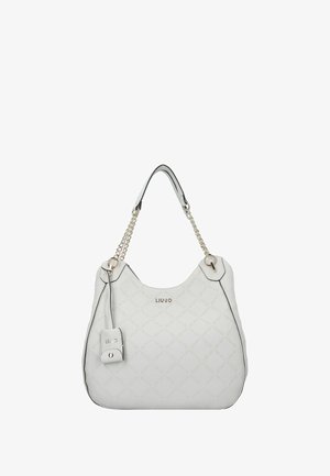 Borsa bianca con motivo trapuntato, rifiniture nere e dettagli in catena dorata. Presenta un'etichetta con logo e una forma rotonda e spaziosa.