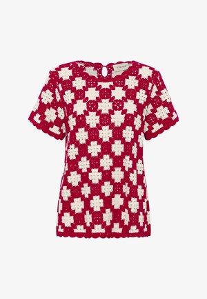 Crvena i bijela heklana bluzica s cvjetnim uzorkom, s okruglim izrezom i kratkim rukavima, završena valovitim rubovima.