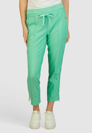 Mintgrüne Hose mit einem Kordelzugbund, seitlichen Taschen und Reißverschlussbündchen. Hergestellt aus einem leichten, glatten Material.