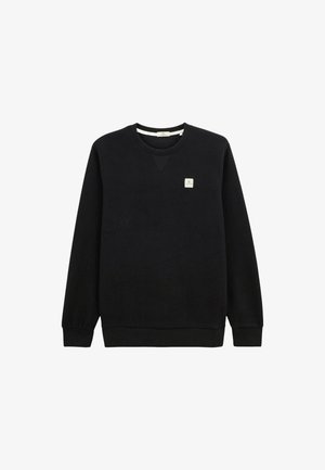 Sweatshirt noir à col ras du cou avec des manches longues, des poignets et un ourlet côtelés, et un petit patch logo carré beige sur la poitrine gauche.