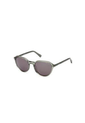 Lunettes de soleil ton gris avec des verres ronds et une monture gris foncé. Branches fines avec un détail de marque subtil. Verres à dégradé foncé offrant une protection solaire.