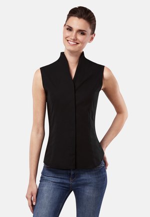 Black sleeveless top with a high collar, fitted design, smooth texture, and visible seams paired with dark blue jeans.
