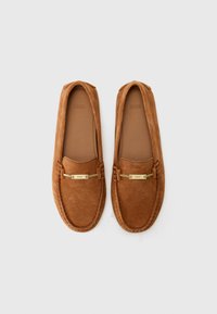 Suede brown loafers with a gold-tone accent and stitched detailing. Smooth inner lining and classic slip-on design. Round toe shape.
