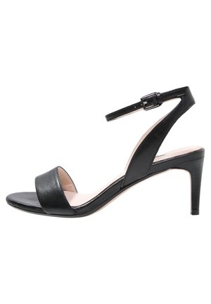 Sandale noire à talons hauts avec un bout ouvert et une bride à la cheville, présentant une texture en cuir lisse et un design de talon effilé.