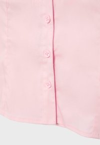 Light pink fabric with sewn button placket featuring four matching pink buttons along one side.