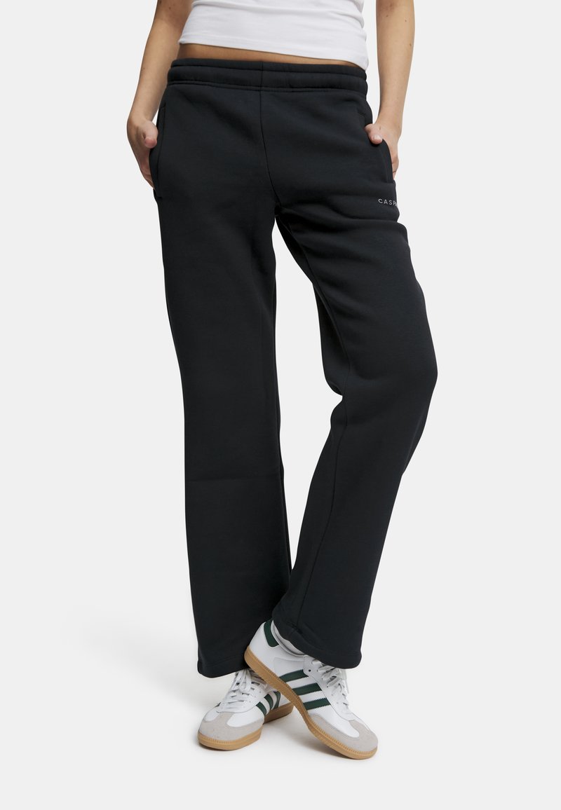 Sorte joggebukser med en avslappet passform, elastisk midje og sidelommer; med en subtil logo foran og en jevn tekstur.