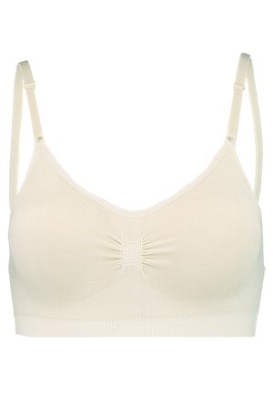Soutien-gorge beige clair avec un design sans coutures, une texture douce et des bretelles réglables. Il présente un détail de centre froncé et aucune armature.