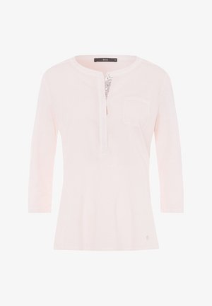 Light pink, long-sleeve top with a henley neckline, a decorative button, and a single chest pocket; made of soft fabric.