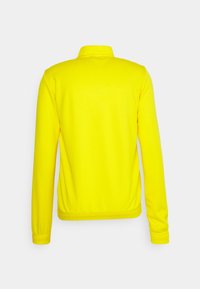 Gul zip-up jakke med krave, lange ærmer og elastiske manchetter og kant. Glat stof uden mønstre eller detaljer.