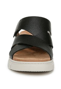 Sandali neri in pelle con design a strap incrociati, caratterizzati da un superiore testurizzato e una soletta in suede beige. La spessa suola bianca offre stabilità.