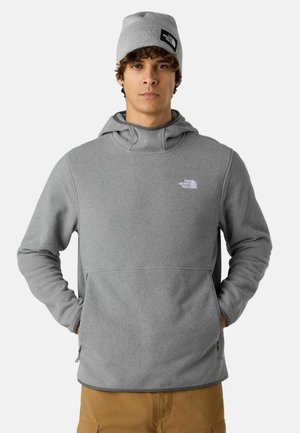 Pullover grigio in pile con tasca a marsupio e cappuccio. Presenta un piccolo logo bianco sul petto e orli a costine. Include anche un berretto abbinato.