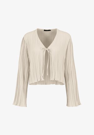 Light beige cropped blouse with long sleeves, featuring vertical pleats and a tie closure at the neckline. Soft, textured fabric.