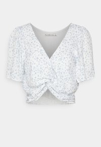 Top corto floral con mangas cortas abullonadas, escote en V, en una combinación de colores azul claro y blanco, detalle de nudo en la parte delantera, tejido texturizado.