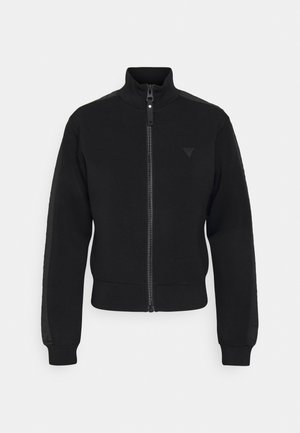 Sweatshirt preto com zíper, gola alta, mangas longas e punhos canelados; apresenta um pequeno detalhe de logótipo na frente. Textura de tecido suave.