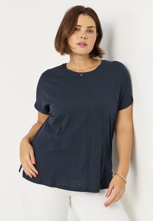 Navy blue, short-sleeve t-shirt with a loose fit and round neckline, featuring a soft, textured fabric and a slightly curved hem.