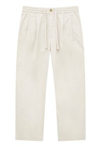 Pantalones de algodón beige con cintura elástica, cordón de ajuste y dos bolsillos laterales; cuentan con un corte relajado y pliegues sutiles en la parte delantera.