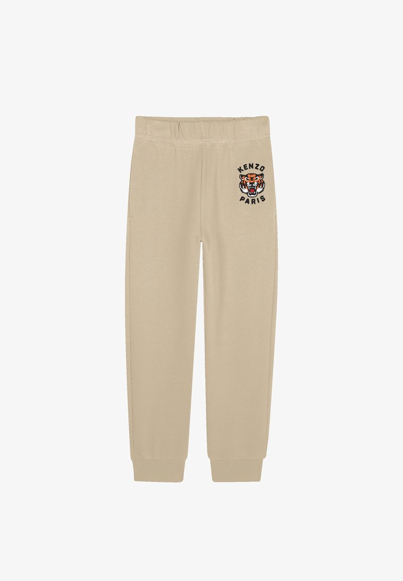 Pantalons de survêtement beiges avec une taille élastique et des poignets élastiques, et un logo tigre avec le texte "KENZO PARIS" en noir sur la cuisse gauche.