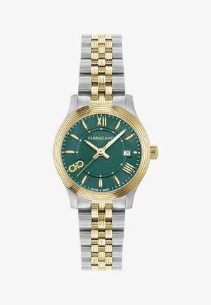 Kuld- ja hõbesinine roostevabast terasest kell rohelise diali, kuldsete rooma numbrite ga ja kuupäeva näidikuga. Omab tekstureeritud rihma disaini.