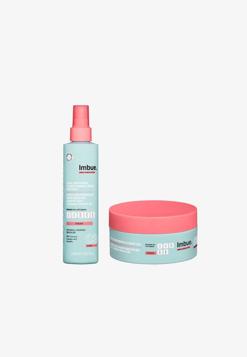 Lichtblauwe sprayfles met een roze pomp en label; ronde lichtblauwe pot met een roze deksel en label. Beide gelabeld "Imbue," vegan.