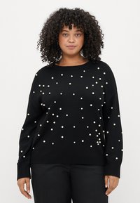 Pulover negru din tricot cu embellishments de perlă albă împrăștiate, decolteu rotund și manșete cu nervuri. Design lejer pentru confort.