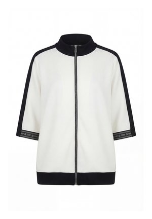 Veste blanche avec col noir, rayures sur les manches et ourlet, fermeture éclair devant et manches trois-quarts avec bordures noires siglées.