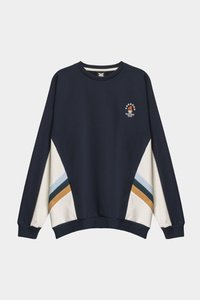 Navy sweatshirt with long sleeves, featuring cream, blue, and gold diagonal stripes. Small logo on the chest. Soft, textured fabric.