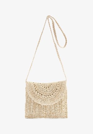 Woven straw crossbody bag in beige, featuring a textured, circular flap and braided strap for secure carrying.
