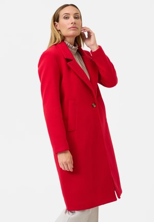 Red coat with a notched collar, single button closure, two side pockets, and a textured fabric. Mid-length design with long sleeves.