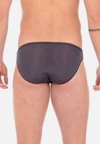 Gray swim briefs made from a smooth, stretchy material, featuring a low-cut design with a narrow waistband and flat seams.