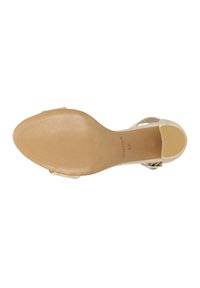 Transparent strappy sandal with a beige rubber sole. Features a textured bottom, open back, and a subtle logo imprint near the heel.