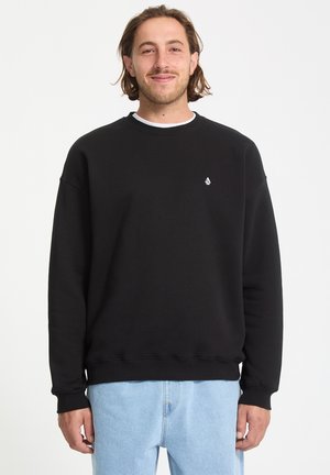 Black sweatshirt made of cotton with a crew neck, loose fit, and ribbed cuffs. Features a small white logo on the left chest.