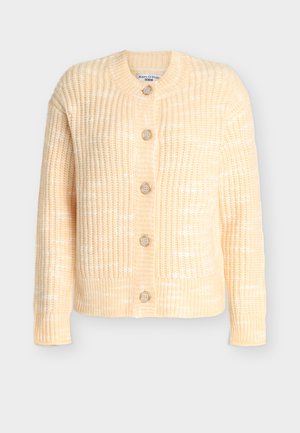 Knitted cardigan in pale yellow with a textured pattern, round neck, and five wooden buttons down the front. Long sleeves, cropped length.