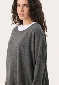 Gray sweater made of soft fabric, featuring a relaxed fit, wide neckline, and long sleeves. Simple design with no patterns or accents.