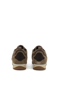 Pair of brown suede and shearling sneakers shown from the back, featuring "BACK 70" branding on the heel tab and sole.