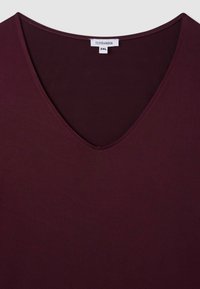 Bordowy t-shirt z dekoltem w serek, wykonany z gładkiego materiału, z prostym wzornictwem oraz metką z napisem "Terranova" i rozmiar 2XL.