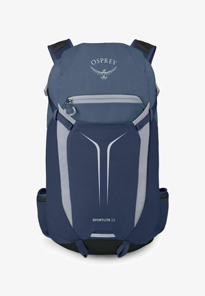 Sac à dos de randonnée bleu Osprey Sportlite 22 avec poche avant zippée et éléments de design réfléchissants.