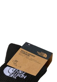 Svarte multisport sokker fra The North Face, pakket med en pappetikett som har logo og størrelse 'M'. Teksturert stoff og ribbet design.