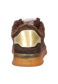 Brown suede sneaker with a fluffy ankle collar, translucent sole, and gold logo accent on the heel. Soft texture and modern design.