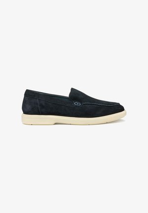 Scarpa slip-on scamosciata blu scuro con punta arrotondata, suola in gomma bianca a contrasto e dettagli di cucitura discreti lungo il vamp.