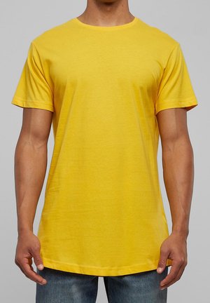T-shirt en coton jaune à manches courtes, col rond, coupe décontractée et ourlet droit. Le tissu semble lisse et légèrement texturé.