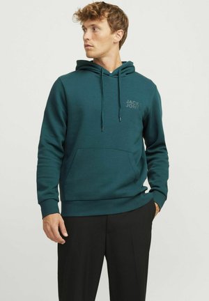 Hooded sweatshirt in dark teal, cotton blend. Features kangaroo pocket, ribbed cuffs, and a printed logo on the chest. Smooth texture.