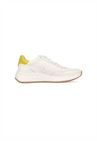 White leather sneaker with a textured surface, yellow heel accent, and a rubber sole. Features a streamlined design and lace-up closure.