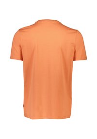 Lyhythihainen t-paita tasaisessa oranssissa, valmistettu pehmeästä puuvillakankaasta. Ominaisuuksina miehusta ja rento istuvuus suoraan helmaan.