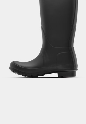 Black rubber rain boot with a smooth surface, round toe, and textured sole for grip. Ankle-high design with a curved side panel detail.