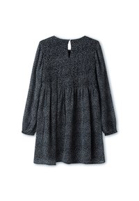 Schwarzes Kleid mit langen Ärmeln, gerafftem Oberteil und Ausschnitt im Rücken. Das Kleid hat ein weißes Punktmuster auf einem strukturierten Stoff.