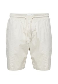 Short beige clair en coton, avec une taille élastique munie d'un cordon de serrage, des poches latérales et une coupe décontractée.